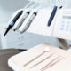 Dental instruments and handpieces on a treatment tray at a dental chair